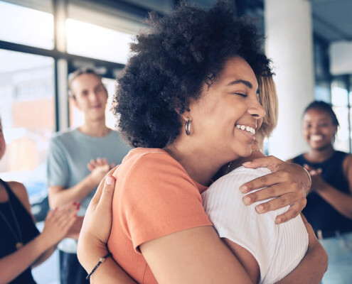 Women hugging in group therapy