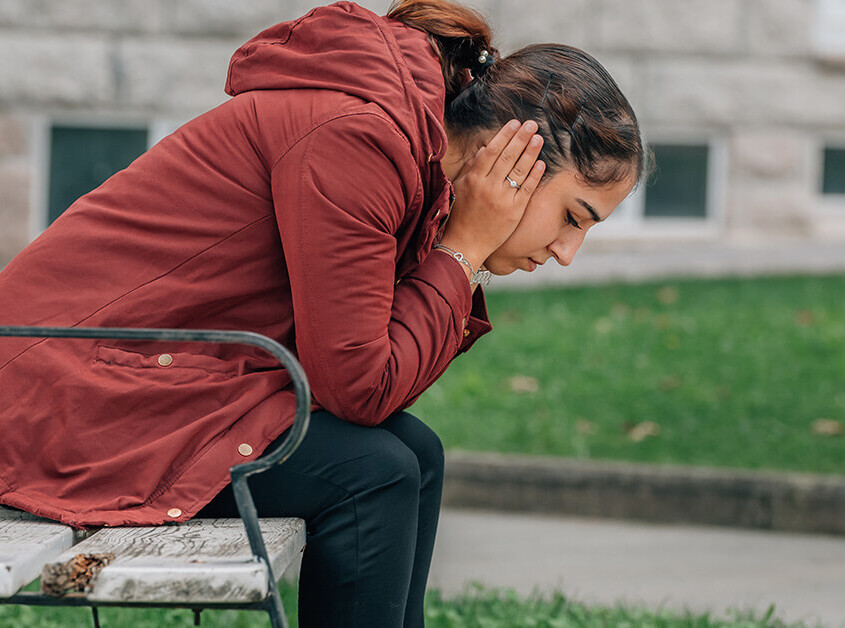 Anxious woman on a park bench
