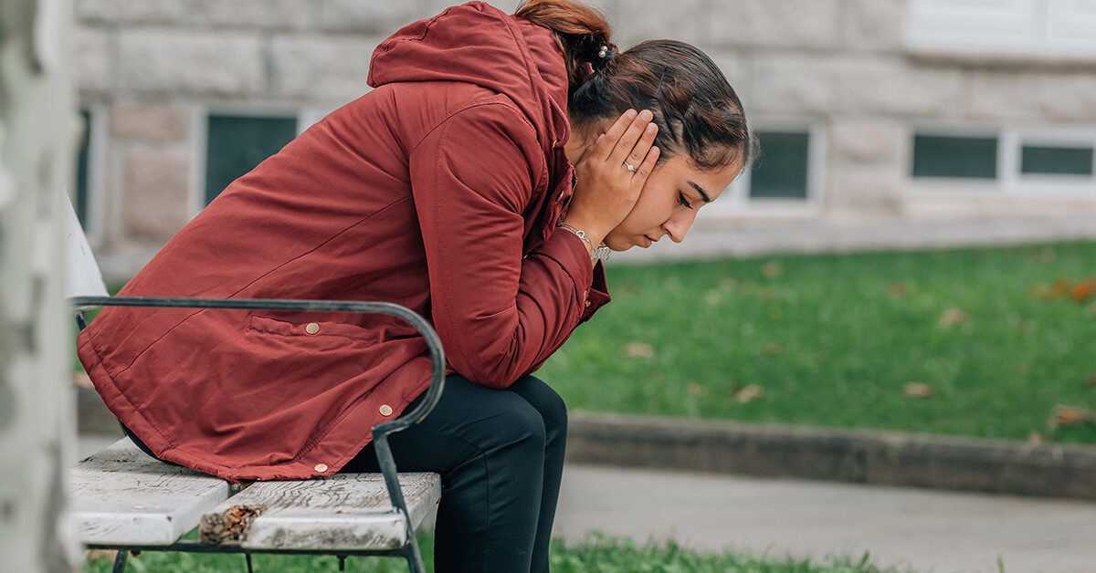 Anxious woman on a park bench