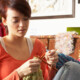 Thoughtful young woman knitting