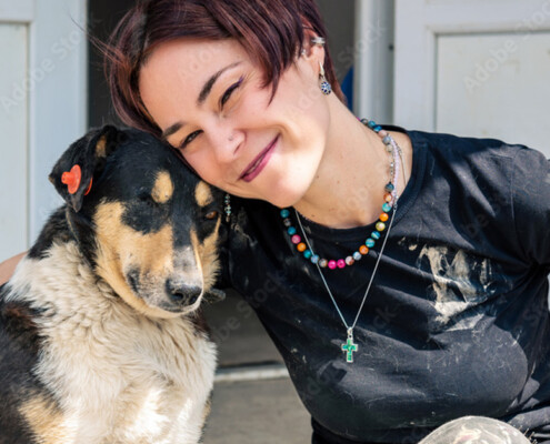 Young compassionate woman with a dog who has been abused.
