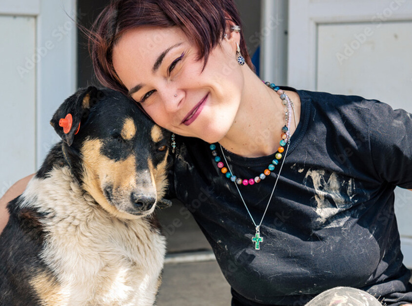 Young compassionate woman with a dog who has been abused.