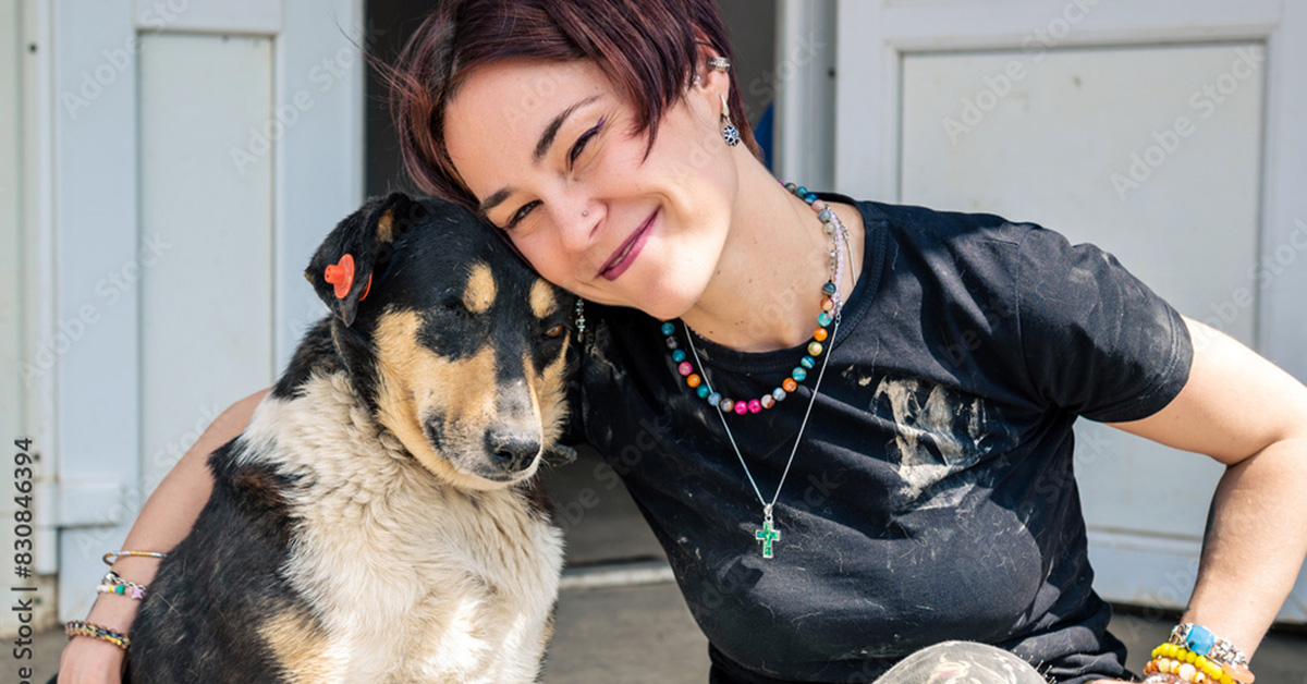 Young compassionate woman with a dog who has been abused.