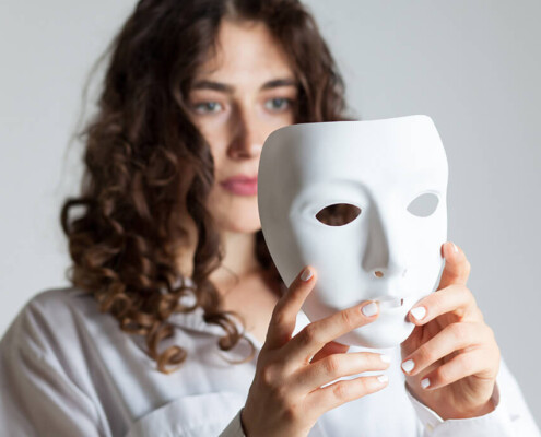 Woman holding a white mask