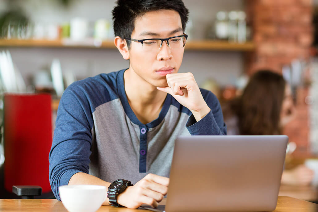 Asian teen at cafe, considering therapy
